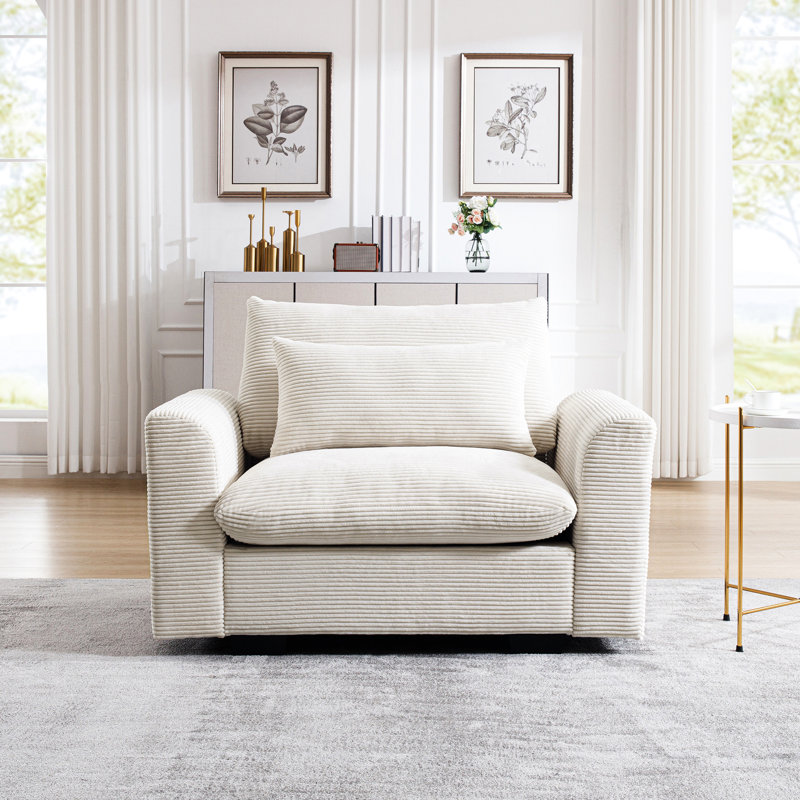 Fauteuil en velours côtelé beige pour une ambiance de détente dans la maison - Coussin de taille élégant