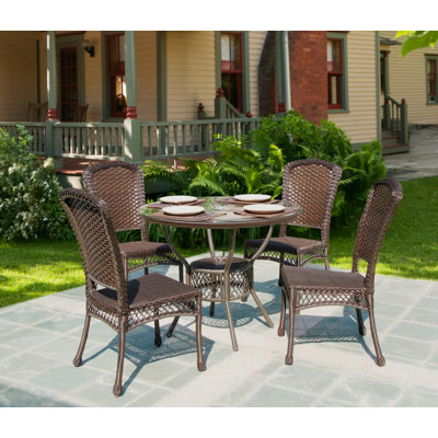 Kohr 4 - Person Wicker Patio Dining Set with Round Table