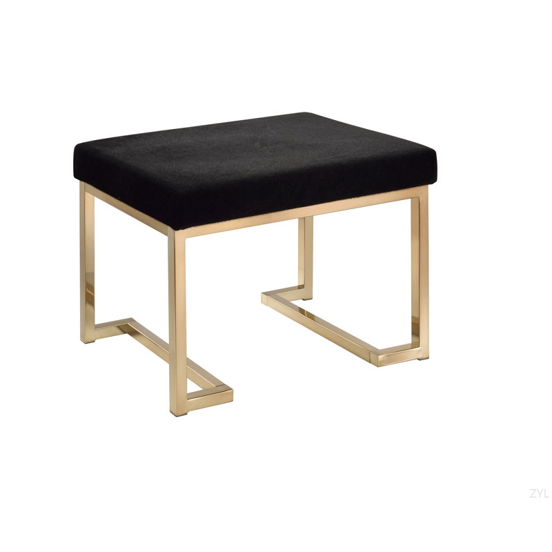 Repose-pieds en tissu noir et finition champagne