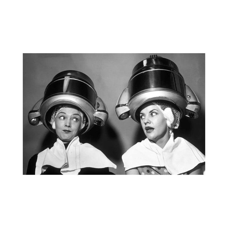 1950s Two Women Sitting Together Gossiping Under Hairdresser Hair Dryer by Vintage Images - Wrapped Canvas Print
