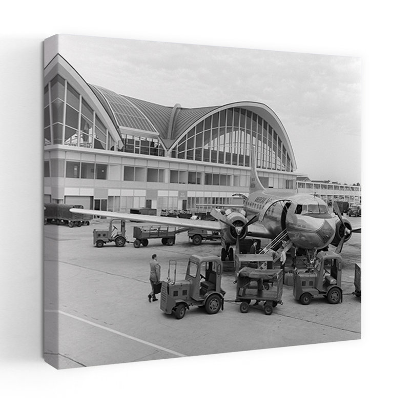 1950s 1960s PROPELLER AIRPLANE ON AIRPORT TARMAC IN FRONT OF TERMINAL WITH MODERN ARCHED WINDOWS ST. LOUIS MISSOURI USA by C. S. Bauer - Wrapped Canvas Print
