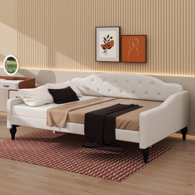 A Full-Size Upholstered Daybed With Tufted Detailing