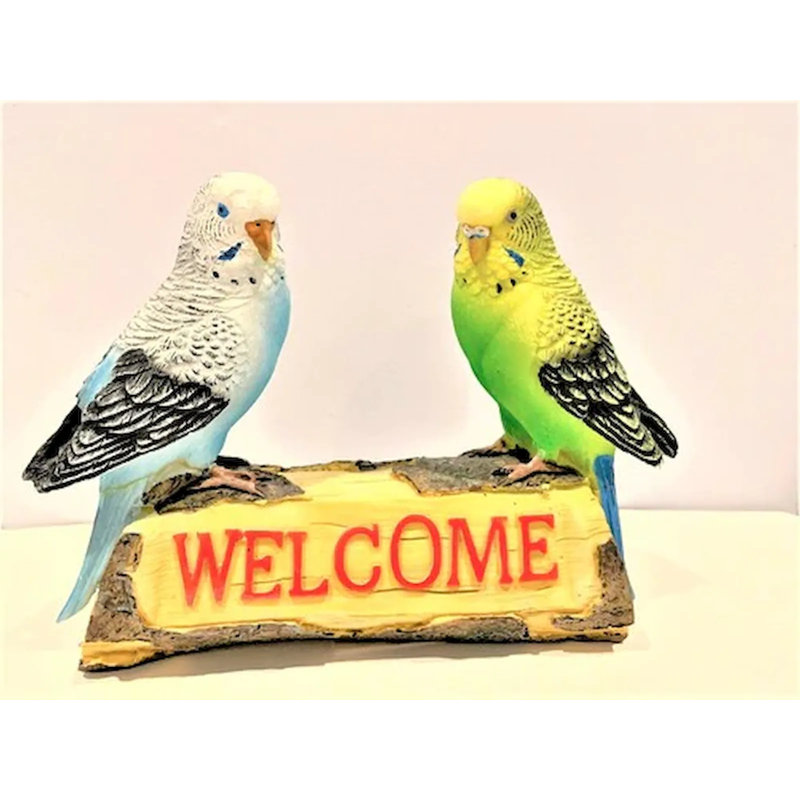 Budgies sur un panneau de bienvenue