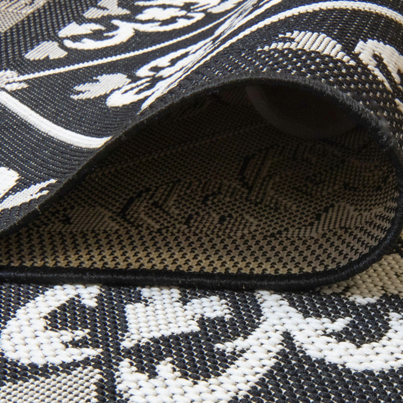 Tapis d'intérieur / extérieur en polypropylène tissé à plat à motif floral noir / blanc Solterra Greti