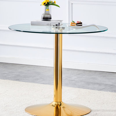 Table ronde de 35 po en verre trempé avec pieds en métal doré, idéal pour les rassemblements sociaux. La salle à manger de 35 po offre une solution élégante