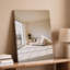 Toile, art intérieur minimaliste avec canapé de couleur claire avec coussins moelleux posés sur une toile murale pâle lisse-528971223