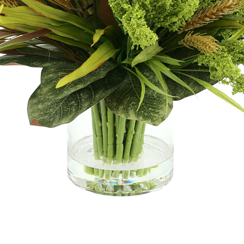Arrangement de bruyère et de blé Lohman dans un vase en verre