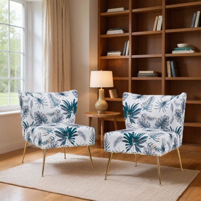 Fauteuil demi-tonneau en velours floral avec dossier courbé et pieds en métal