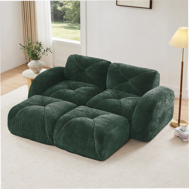 Canapé en forme de U sans os avec revêtement en velours capitonné, support ergonomique et repose-pieds amovibles pour des sièges flexibles.