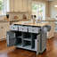 Îlot de préparation mobile gris et bleu pour la salle à manger, surface de travail pliante en bois d'hévéa, supports de rangement pour porte intégrée, 1 armoire fermée et 3 tiroirs, 5 roulettes à roulement en douceur