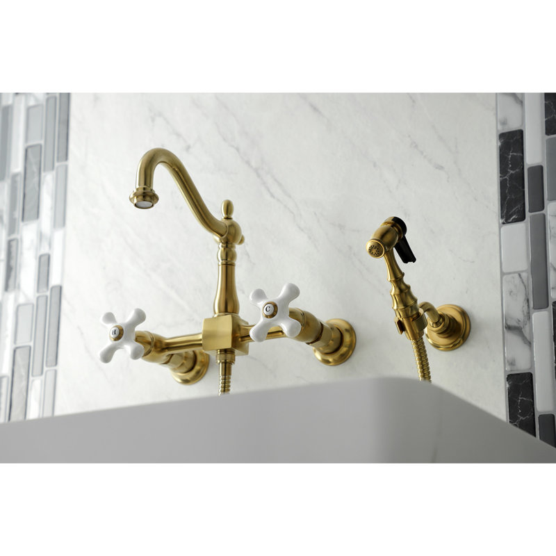 Kingston Brass Heritage Double-Handle 3-Hole Wall-Mount Bridge Kitchen Faucet with Brass Sprayer, Satin Brass