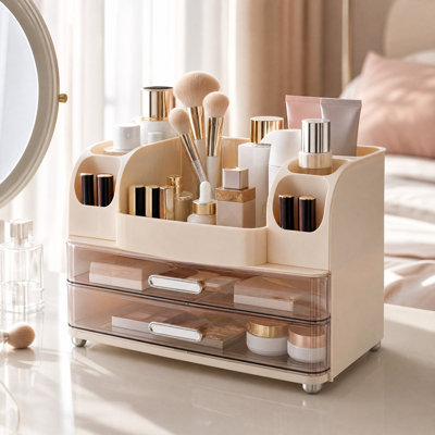 Organisateur de maquillage en plastique avec 2 tiroirs transparents, multicompartiments et fentes latérales, idéal pour coiffeuse ou salle de bain.
