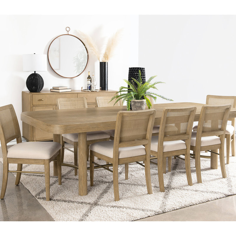 Table de salle à manger rectangulaire couleur sable avec bar en laiton antique, rallonge amovible et configuration flexible pour 8 personnes. Style bord de mer. Autoportante, coins arrondis.