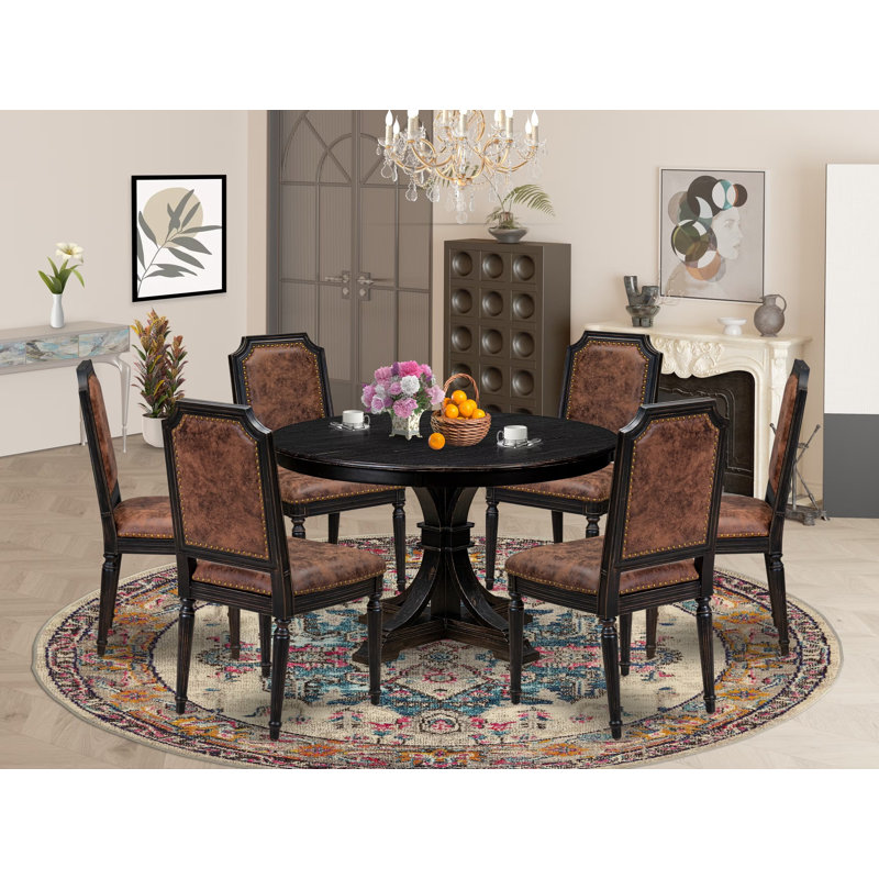 L'ensemble de salle à manger 7 pièces comprend une table ronde et 6 chaises en polyester noir sablage