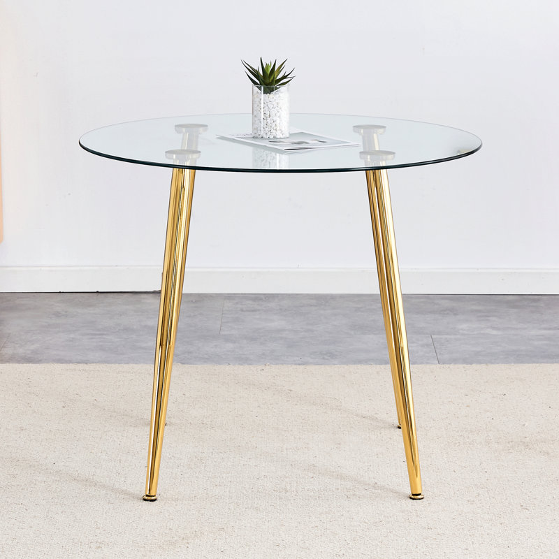 Table de salle à manger spacieuse à plateau rond en verre, pieds en métal doré moderne, idéale pour les repas à la maison