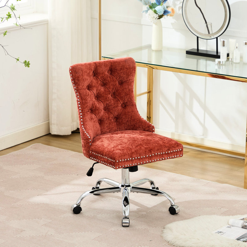 Fauteuil de bureau orange rotatif rembourré à boutons orange, base en métal, coussin à rebond élevé, boutons tirés à la main, garniture cloutée décorative, réglable