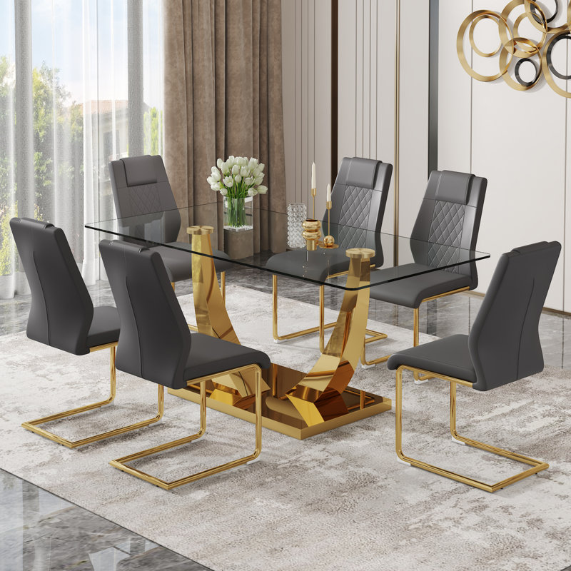 Table de salle à manger moderne avec plateau en verre trempé transparent et pieds en métal plaqué or