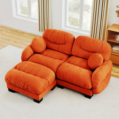 Canapé modulaire 2 places avec accoudoirs courbés, repose-pieds et coussins décoratifs