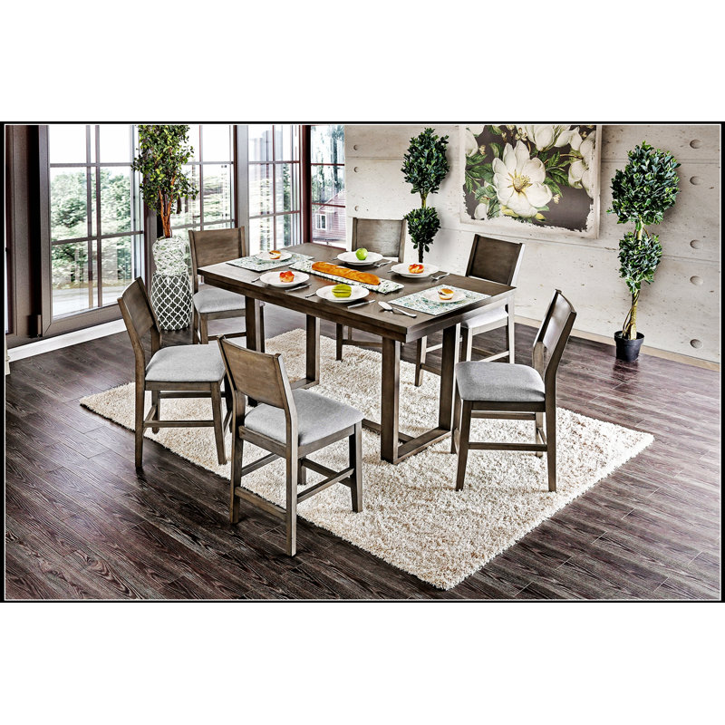 Ensemble de table de salle à manger 7 pièces à hauteur de comptoir avec table grise et chaises rembourrées en tissu, parfait pour les espaces compacts et les maisons urbaines.