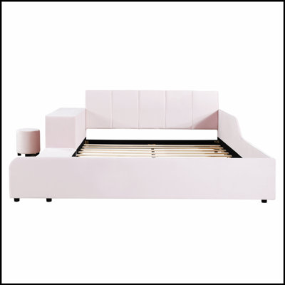 Lit tapissier au sol avec bureau de chevet intégré et tabouret rond confortable, parfait pour les chambres modernes et peu encombrant.