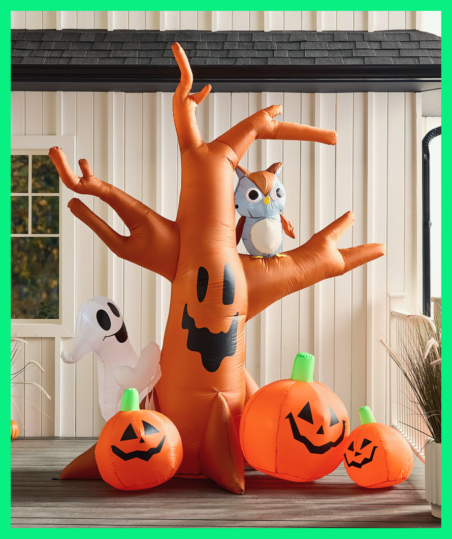 Inflatable Halloween tree with owl, ghost, and pumpkins.