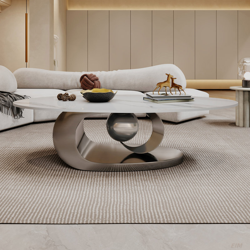 Table basse en marbre avec base sculpturale en acier inoxydable