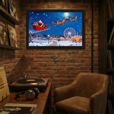 Père Noël de Noël survolant le parc d'attractions d'hiver