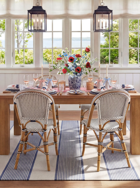 Dining room with red, white, and blue floral centerpiece.