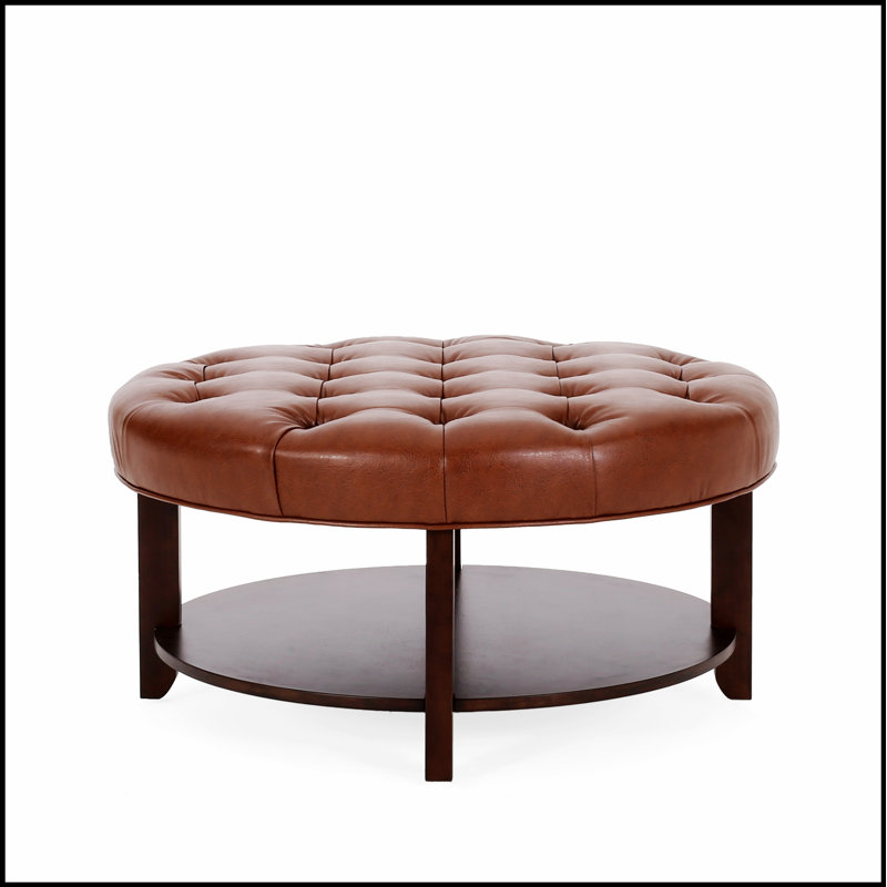 Repose-pieds rond avec capitonnage à boutons, intérieur en similicuir et tablettes ouvertes pour un décor moderne
