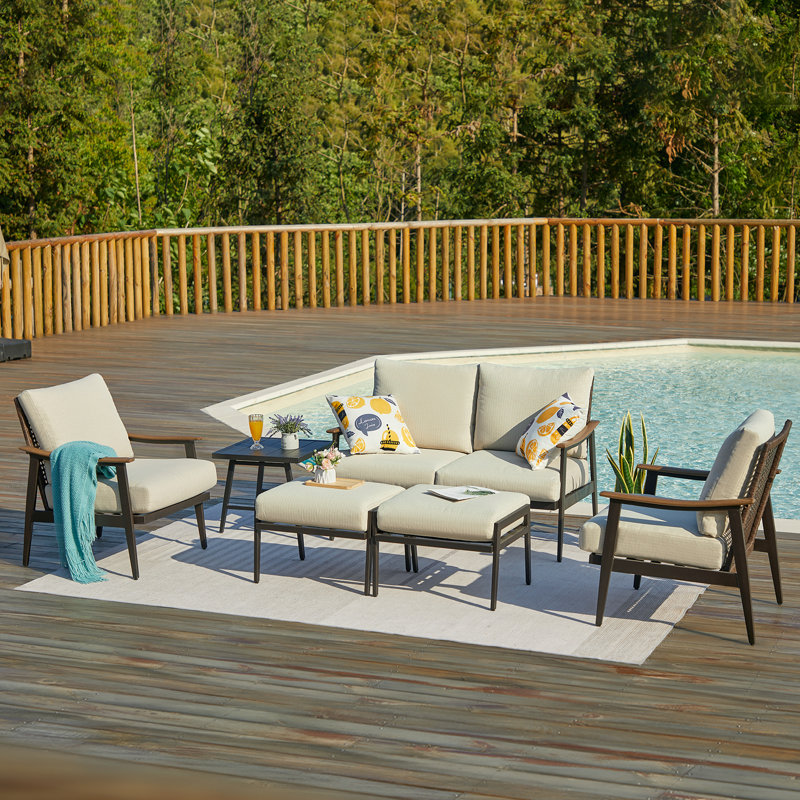 Itsuro 4 - Person Wicker Back Outdoor Seating Group with Ottomans and Thick Cushions