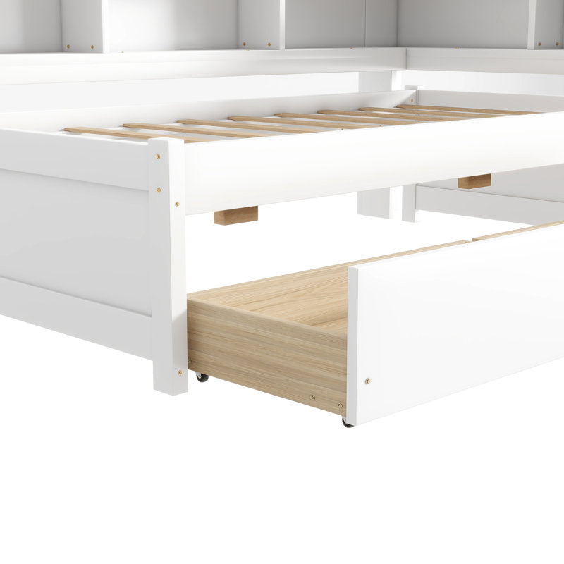 Lit simple en forme de L avec bibliothèques blanches, prises de courant, commode et deux tiroirs de rangement