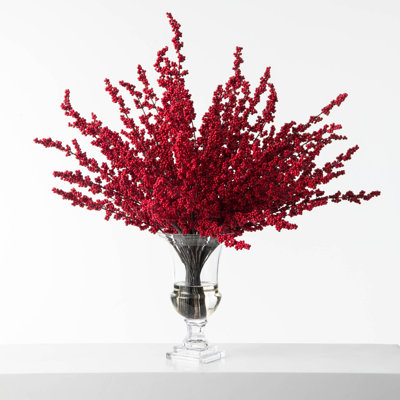 Arrangement de branches de baies rouges dans un vase d'urne