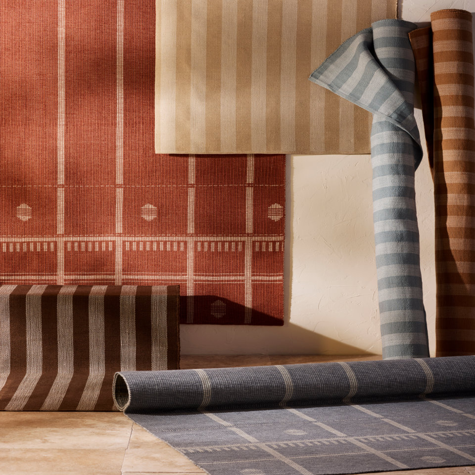 Display of assorted rugs.