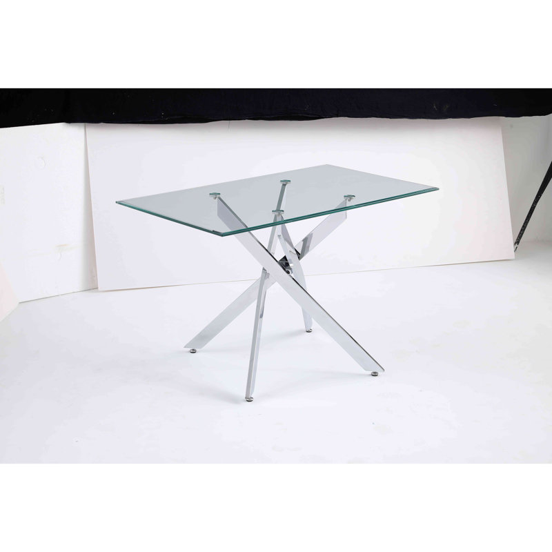 Le plateau de table rectangulaire moderne en verre trempé est jumelé à un cadre en fer