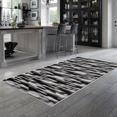 Tapis gris en polyamide sanglé Sanguine