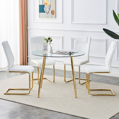 Ensemble de table et de chaises. Table de salle à manger ronde, plateau de table en verre et pieds en métal plaqué or, jumelé à 4 coussins en polyuréthane et une chaise de salle à manger avec pieds en métal plaqué or. DT1164