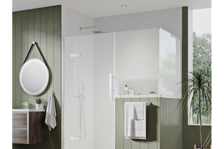 white tiled glass door shower in a bathroom with green shiplap walls. Round wall mirror above a wood floating vanity