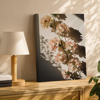 Canvas A Delicate Arrangement Of Soft Pale Pink Flowers Gracefully Drapes Wall Art Across A Light Colored Wall Casting Intricate Canvas Wall Art