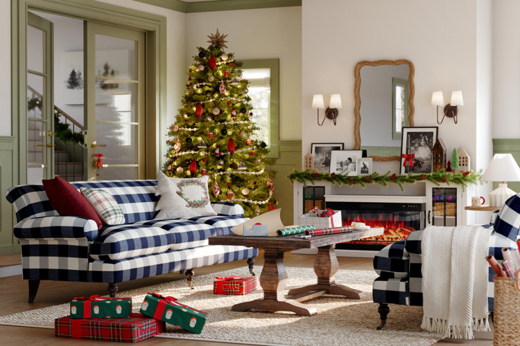 living room decorated for christmas with tall tree, gold bow topper, colorful ornaments, and gingham sofa with accent pillows