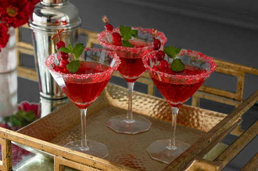 A gold tray of holiday cocktails.