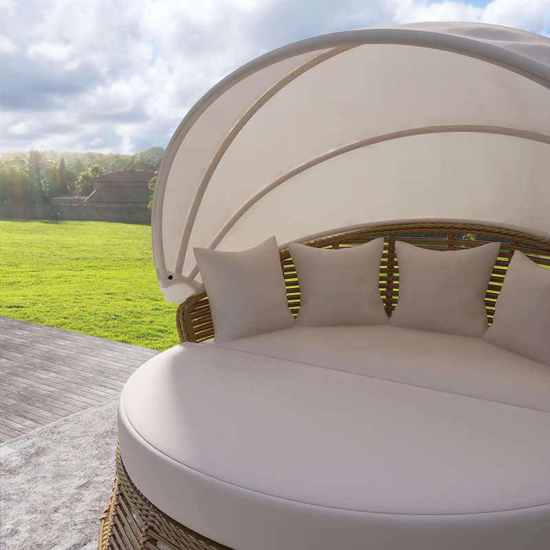 Lit de jour rond en rotin d'extérieur beige avec auvent rétractable et coussins amovibles