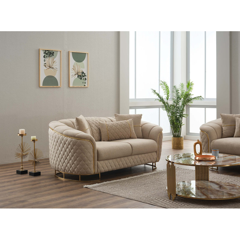 Causeuse rembourrée avec détails matelassés et base dorée