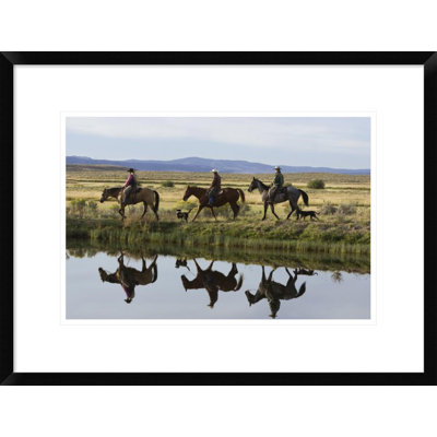 " Cowboys And A Cowgirl Riding Horses Beside Pond "