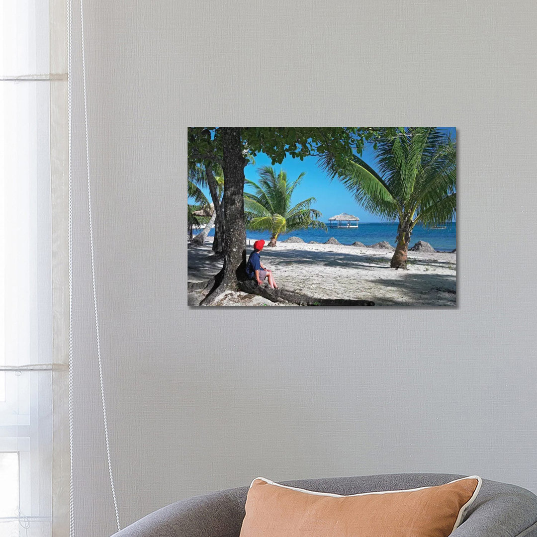Tourist Resting Under Palm Trees On Beach At Palmetto Bay, Roatan Island, Honduras
