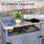 Banc de rempotage extérieur gris. Bois avec compartiment de rangement. Surface de travail en aluminium. Roues en caoutchouc pour un mouvement pratique. Rouille. Pour le jardinage des fruits. Rangement pour banc l 32,81 po x P 16 po x H 37,5 po.