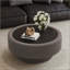 Table basse ronde cannelée avec rangement, plateau en verre trempé et revêtement en cuir gris.