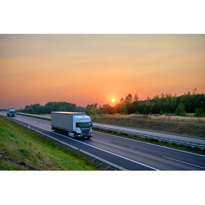White Trucks Driving On The Asphalt Highway At Sunset - Wrapped Canvas Print