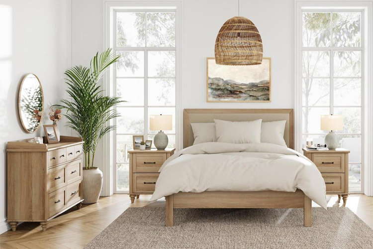 bright neutral bedroom with a wooden bed, matching nightstands, dresser, and woven pendant light
