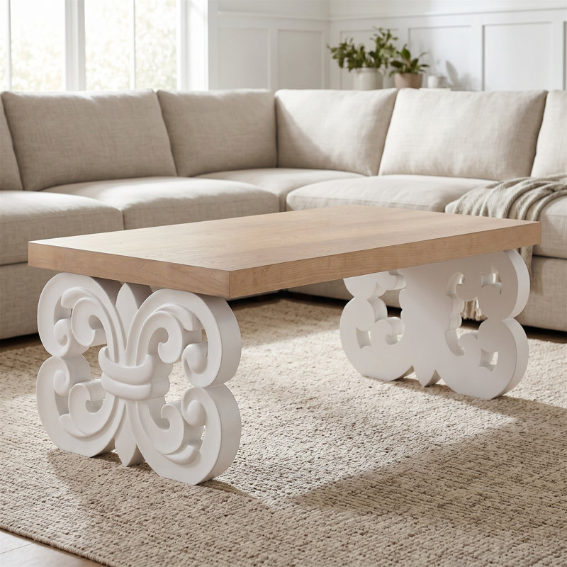 Table basse rectangulaire, base à volutes noire, petite table solide avec double piédestal, design rétro sculpté, plateau de table spacieux, style maison de campagne moderne.