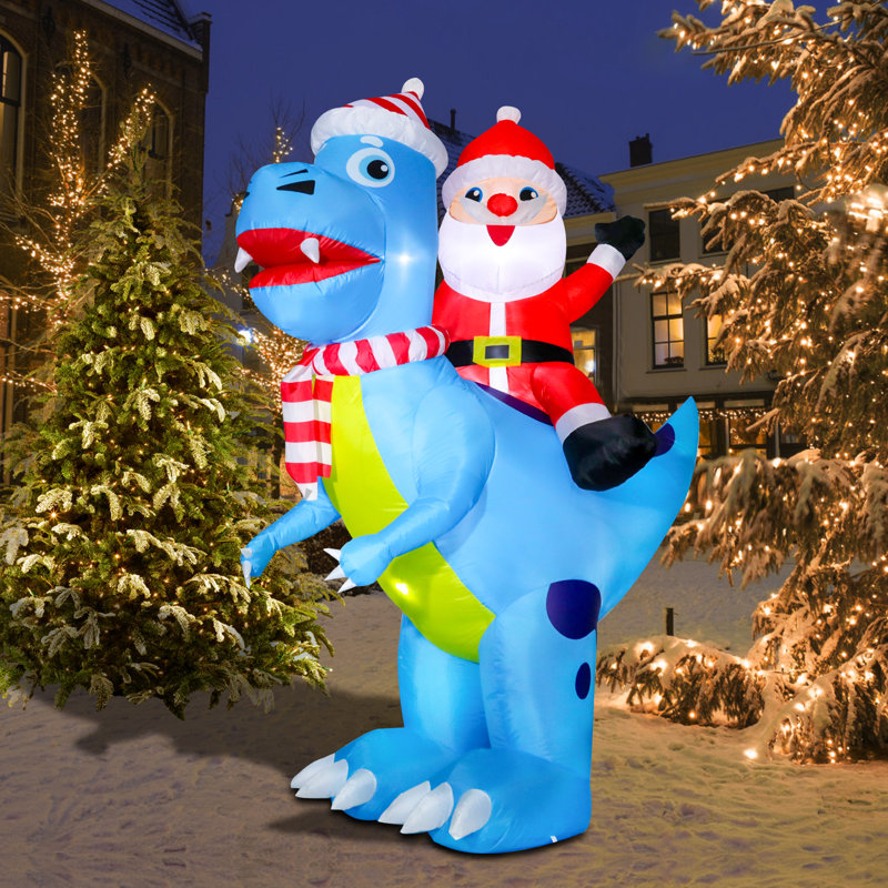 Père Noël sur un dinosaure gonflable